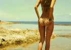 Teen with a superb ass covered in sand