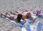Braless babes tanning on the hot sands